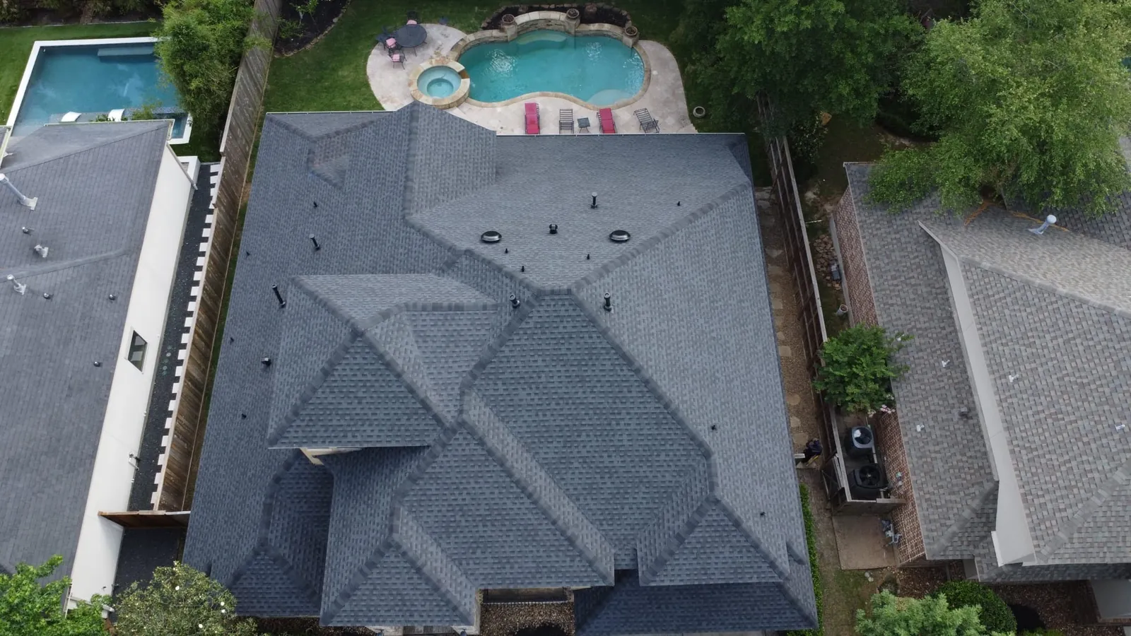 Aerial view of a TexVen Roofing project — a freshly installed shingle roof on a Houston home